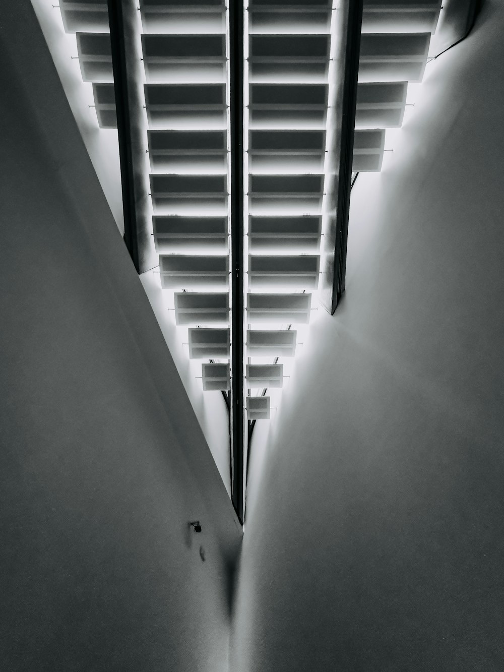 a black and white photo of a window with blinds