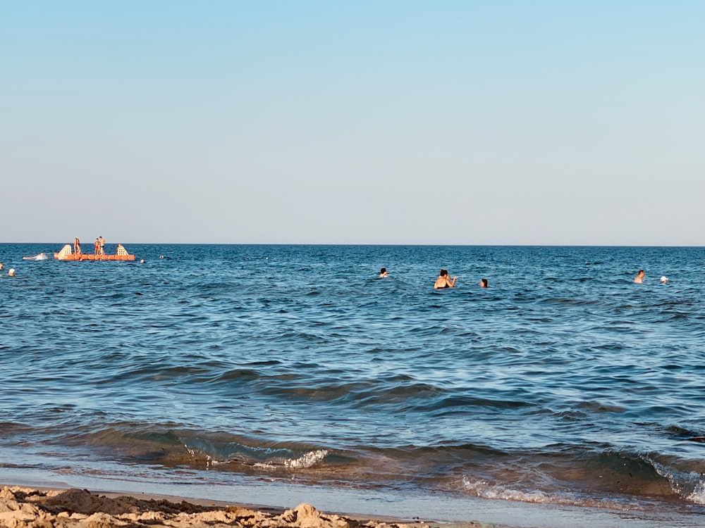 people on body of water across horizon