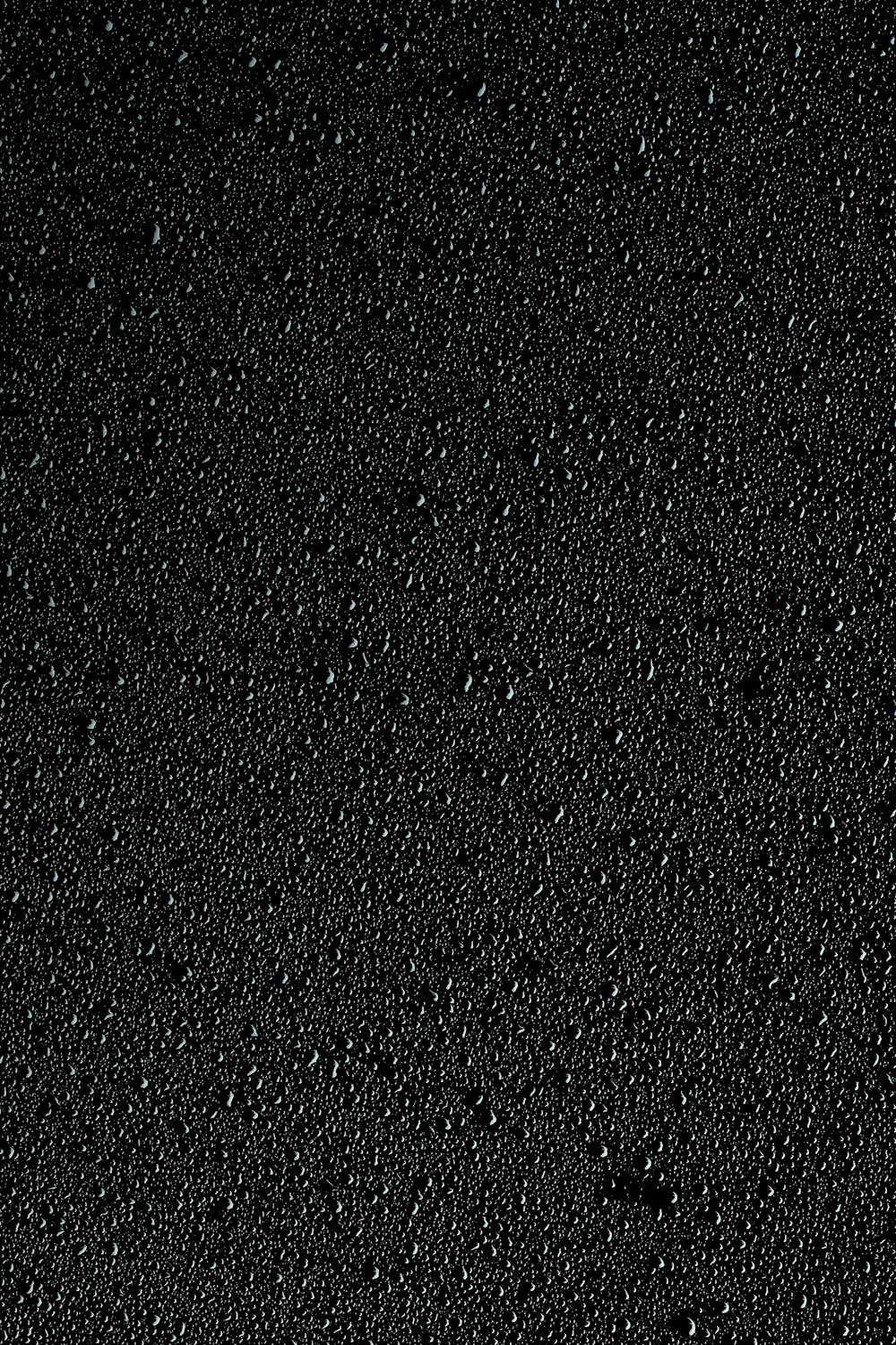 ein schwarzer Hintergrund mit kleinen Wasserblasen