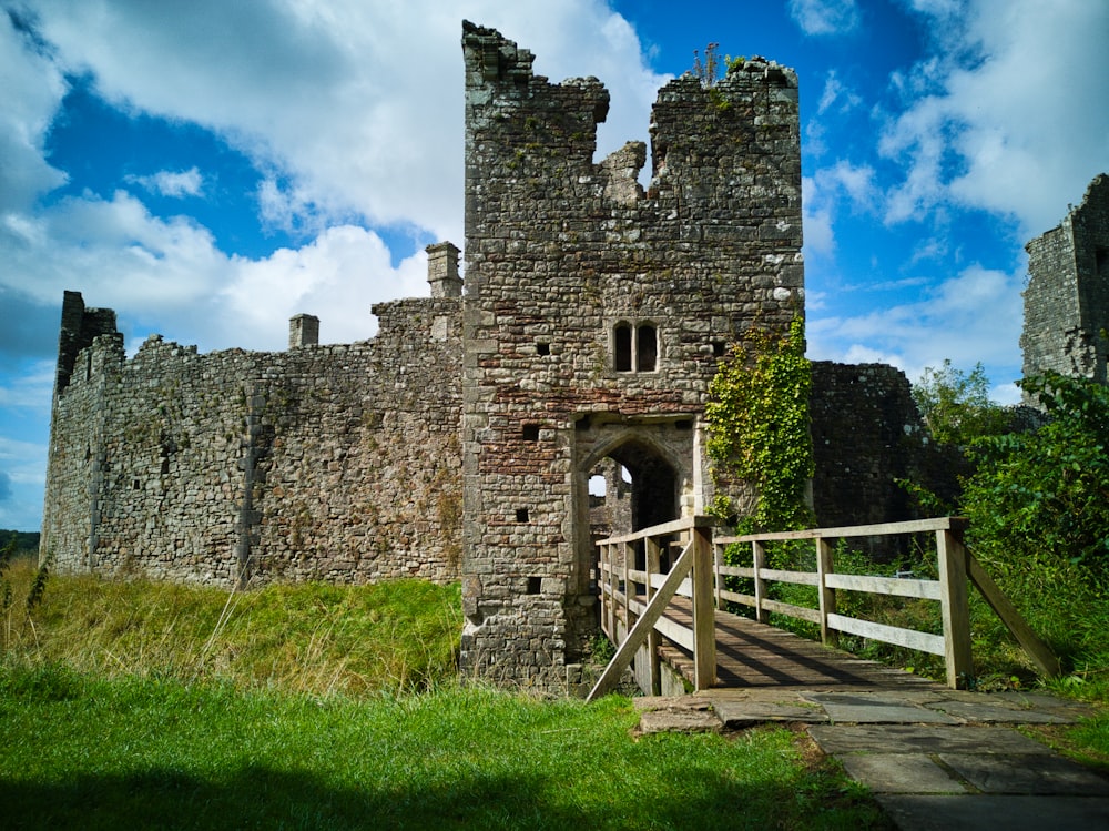 photo of brown wooden boardwalk and brick castle