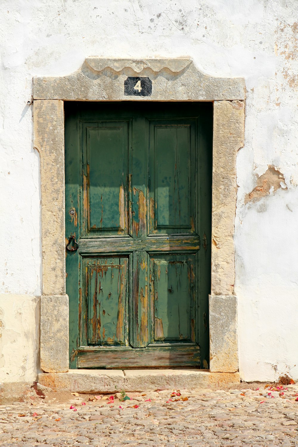 green wooden 4-panel door