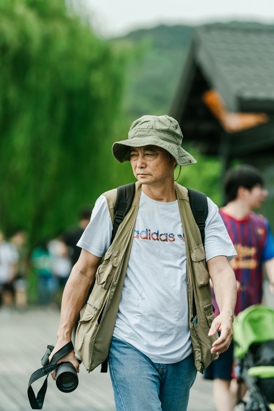 man holding black DSLR camera during daytime