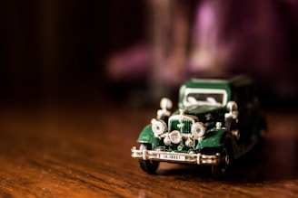 A vintage car model displayed on a wooden table.
