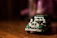 Close-up of a detailed vintage diecast car model on a wooden shelf.