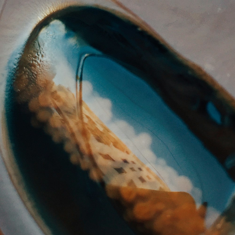 a reflection of a building in a bowl of water