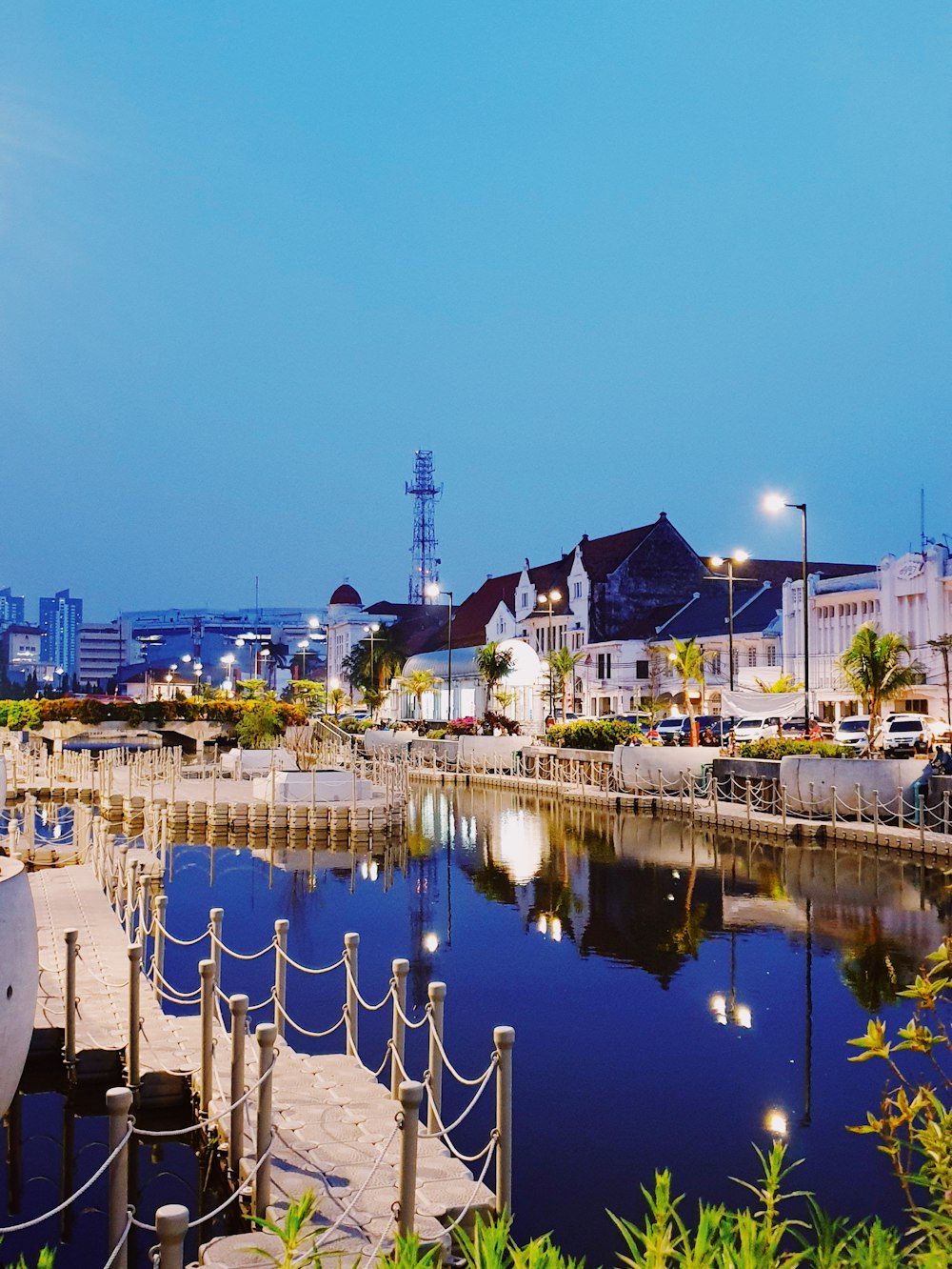 lighted buildings near body of water during nighttime