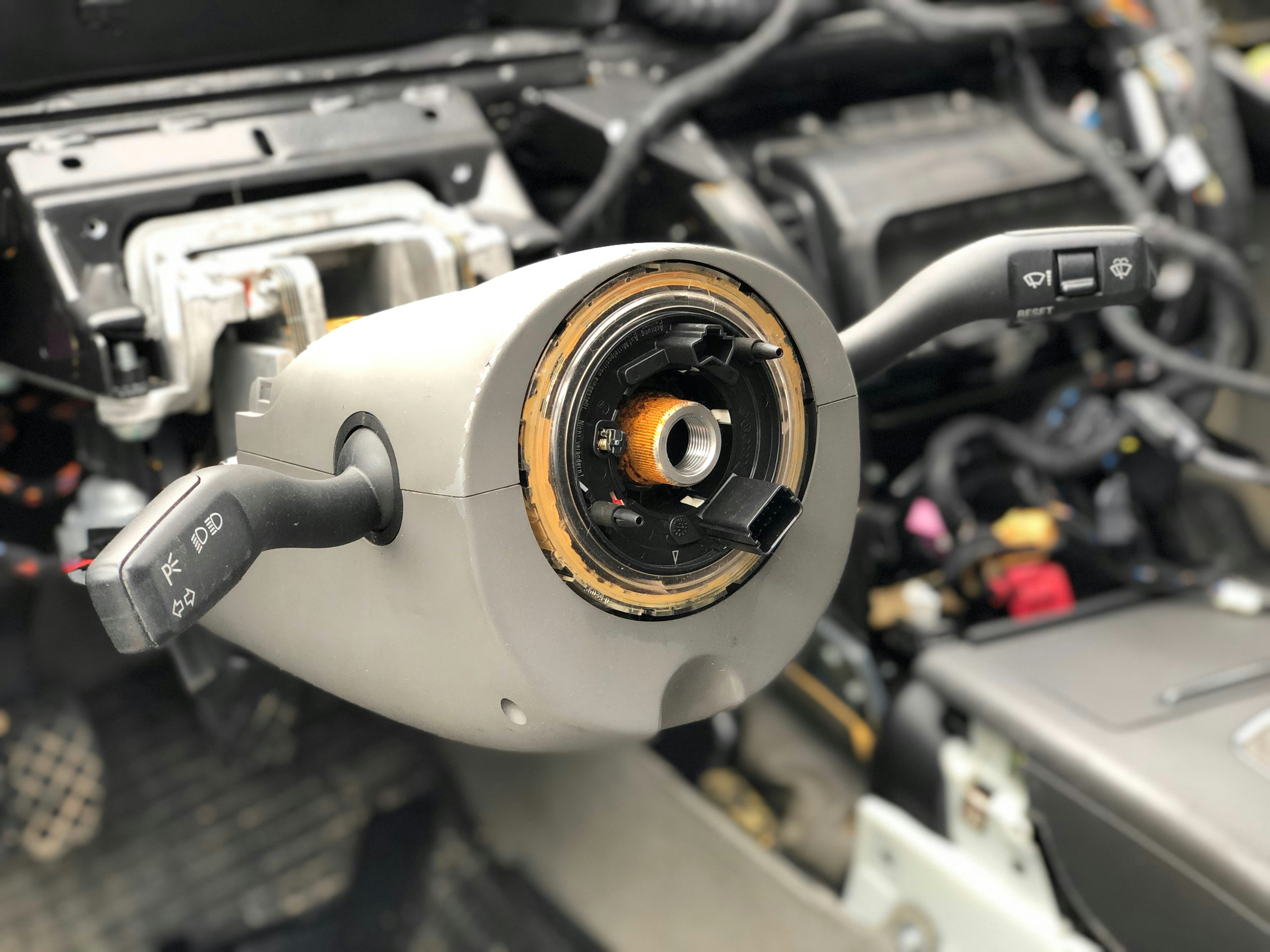 Mechanic removing worn spark plugs during a modern car tune-up