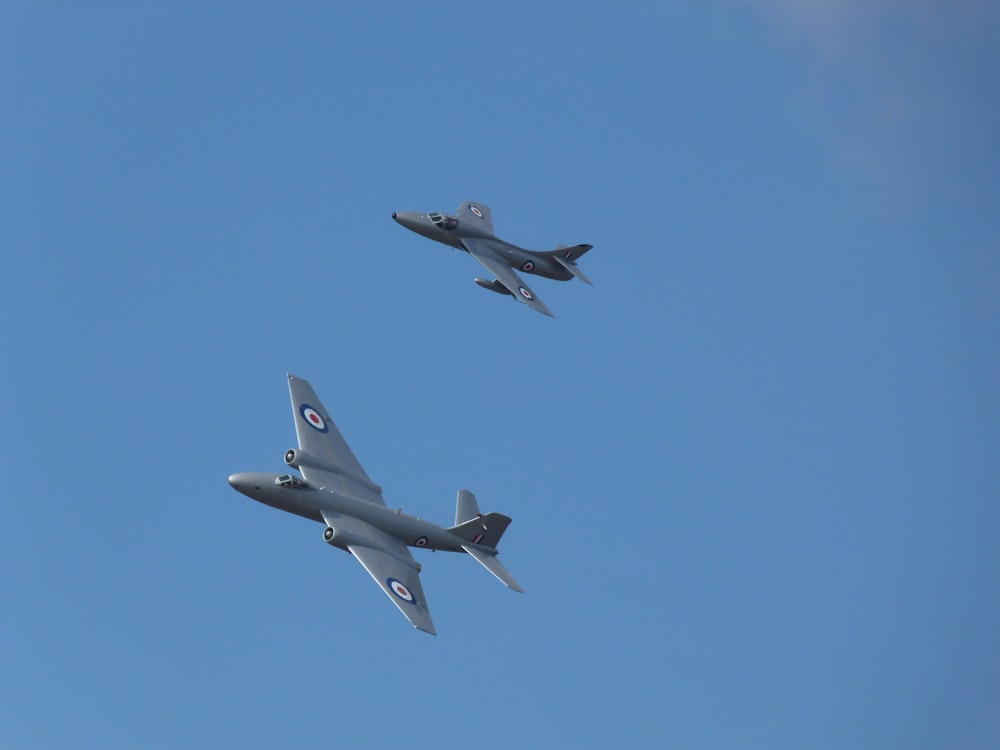 two flying gray jet planes