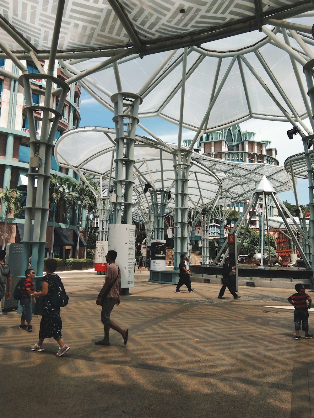 people walking under shade