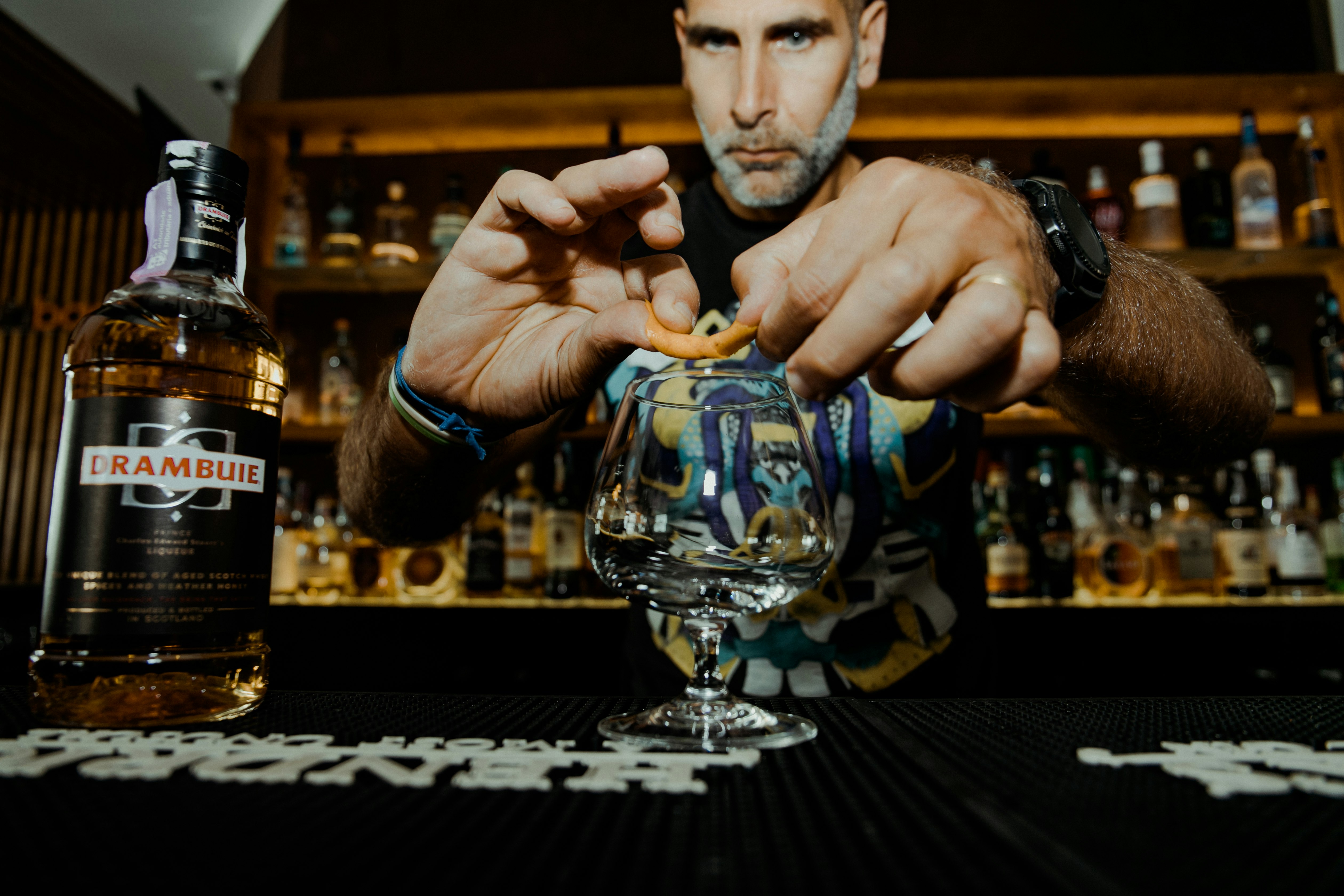 man putting pastry on wine glass