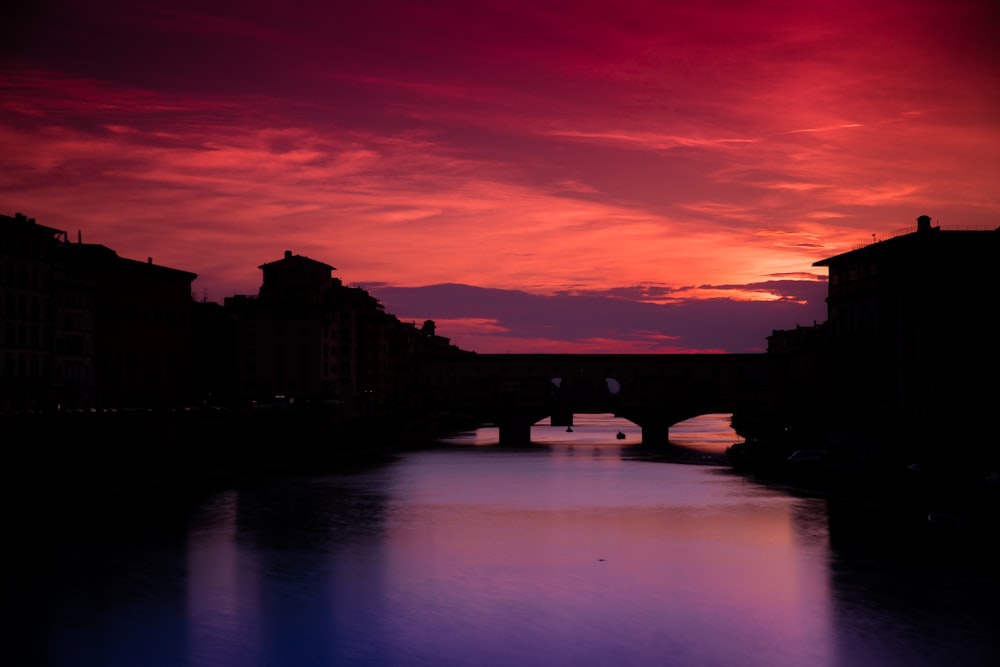 a river with a bridge in the middle of it