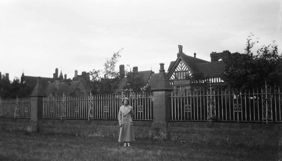 woman standing beside house