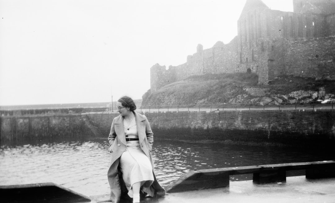 greyscale photography of woman wearing coat