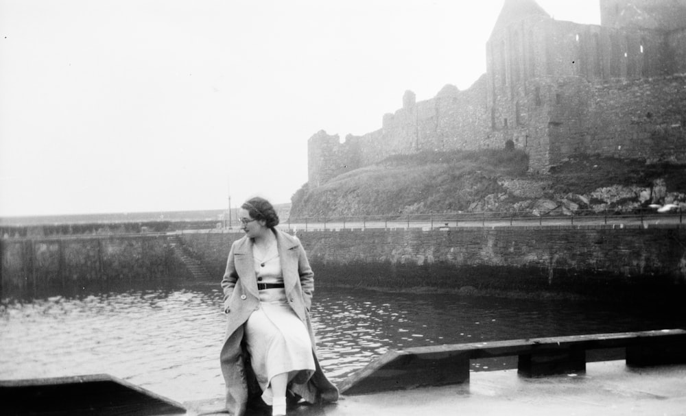 greyscale photography of woman wearing coat