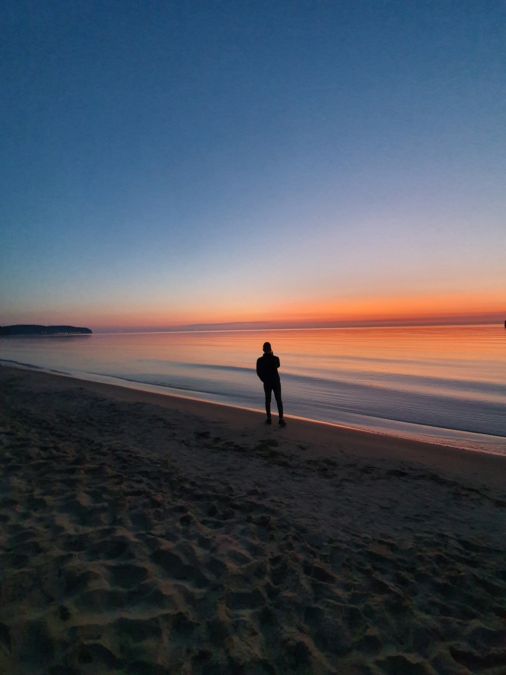 silhouette photo of man near beach