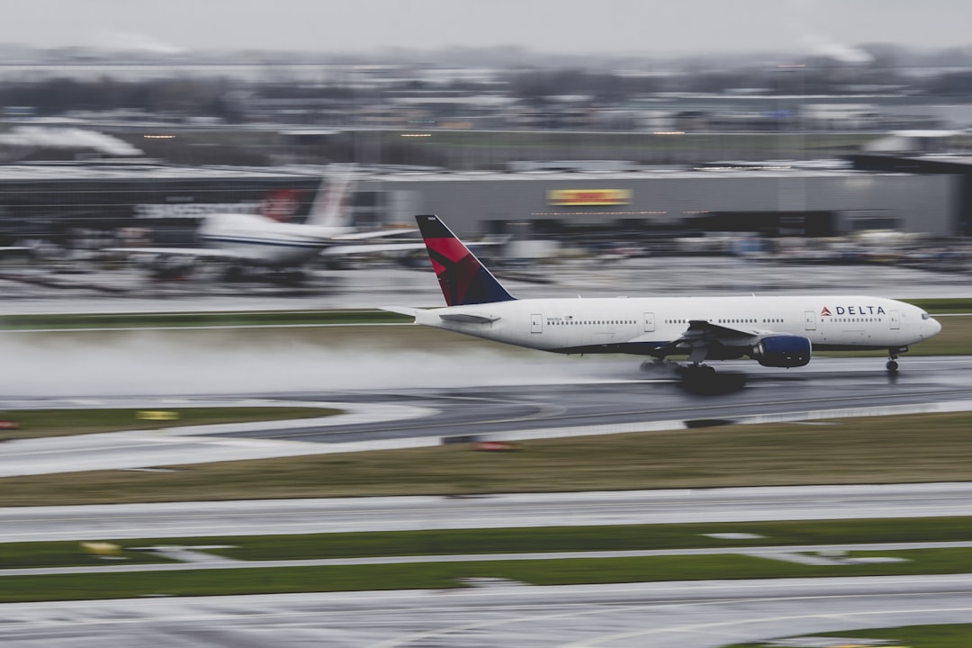 airplane about to taking off on airfield during day, Delta 767 departing from Amsterdam during heavy rain