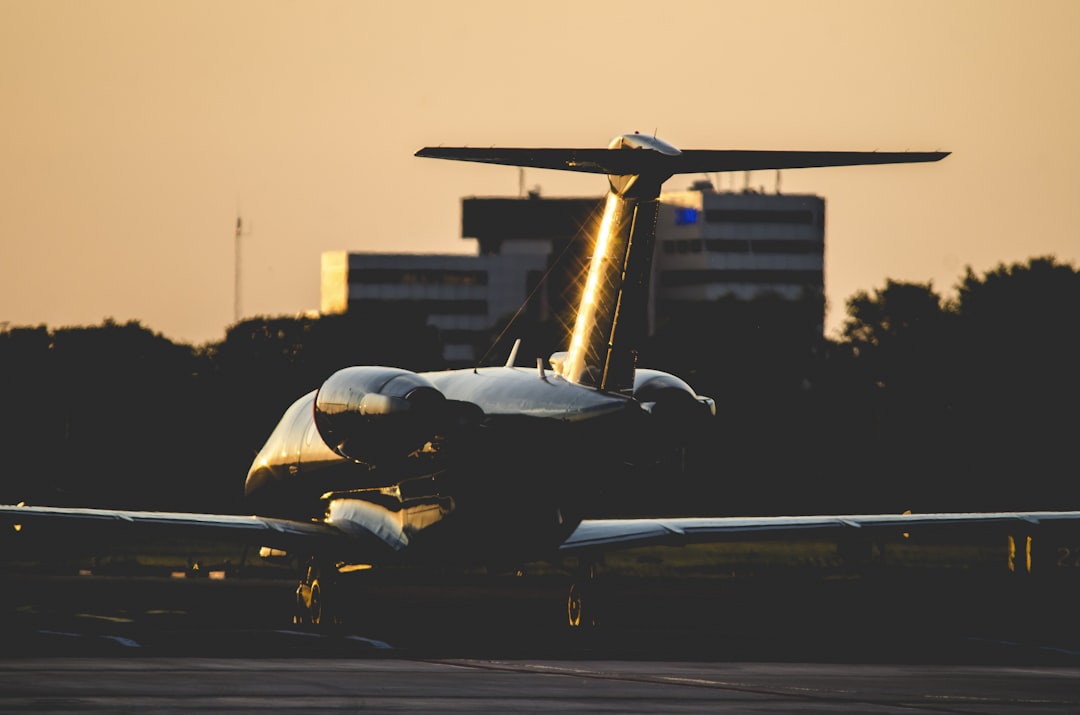 airplane in airport, Sun sets behind jet at Schiphol Airport
