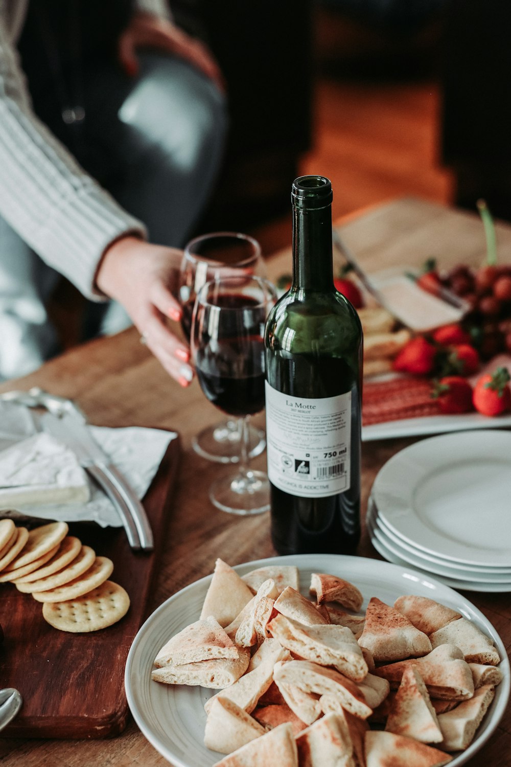 wine bottle beside two clear wine glasses on table