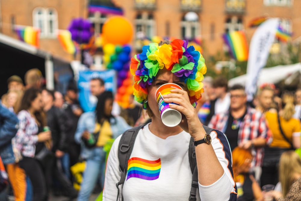 shallow focus photo of person drinking on multicolored crup