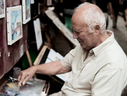 man painting on canvas