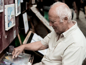 man painting on canvas