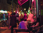 Evening view of downtown caffe’s shisha lounge with guests relaxing and soft ambient lighting.