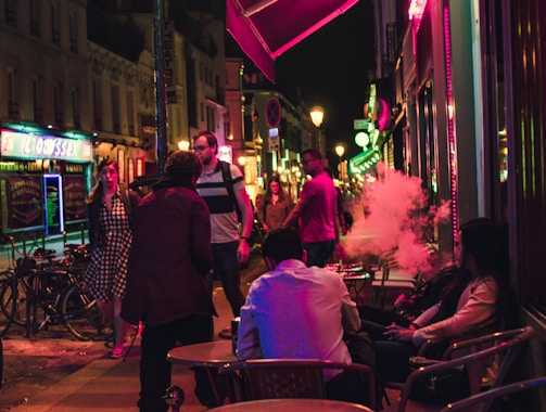 A lively night scene with patrons enjoying live tarab music under warm lantern light at mijana.