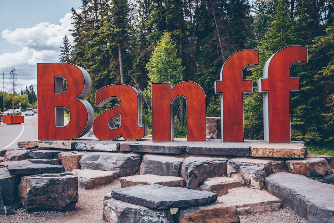 Banff freestanding letters on rocks beside road and trees