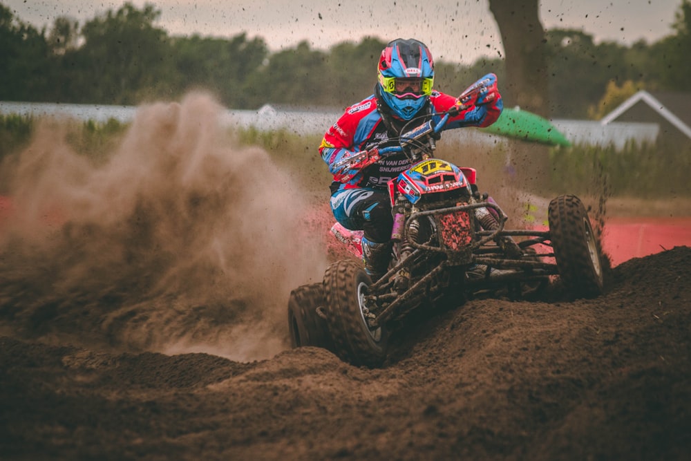 man riding ATV on dirt road