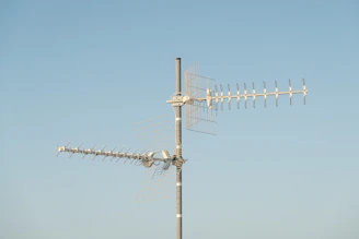 Close-up of a high-quality TV antenna mounted on a rooftop against a clear sky