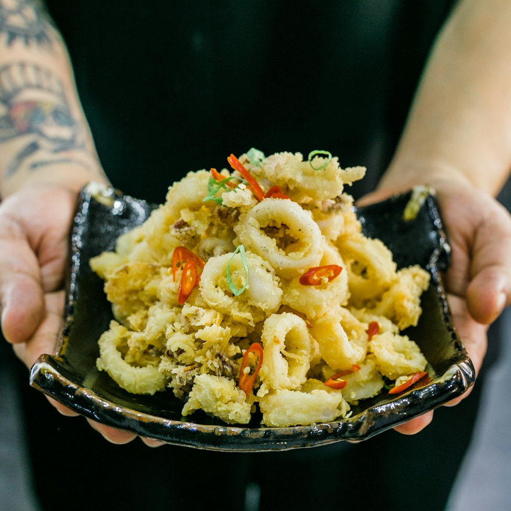 person holding plate with food