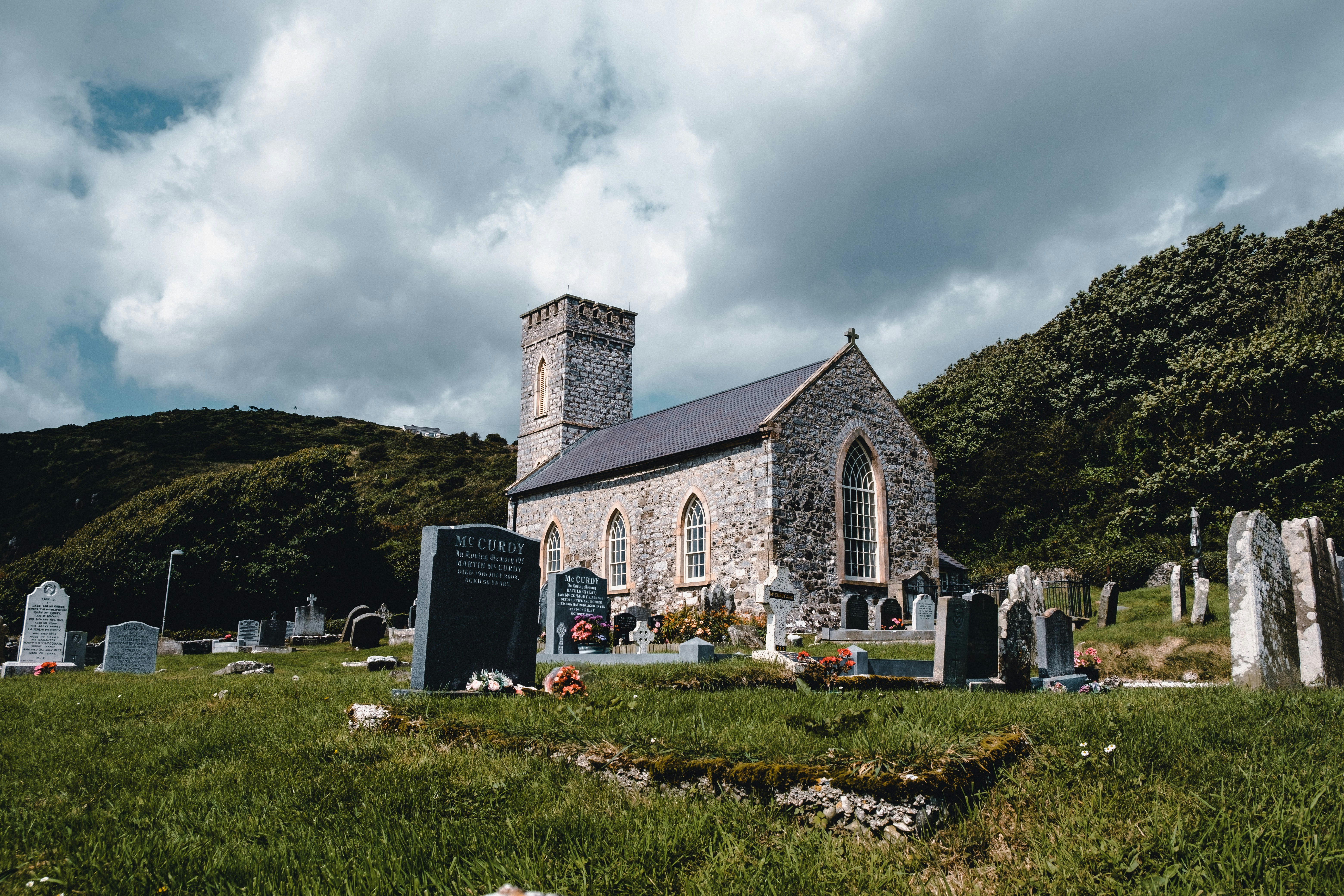 white and gray concrete cathedral near green mountains