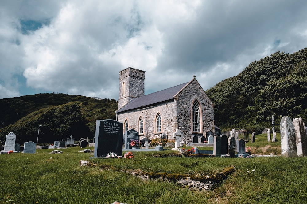 white and gray concrete cathedral near green mountains