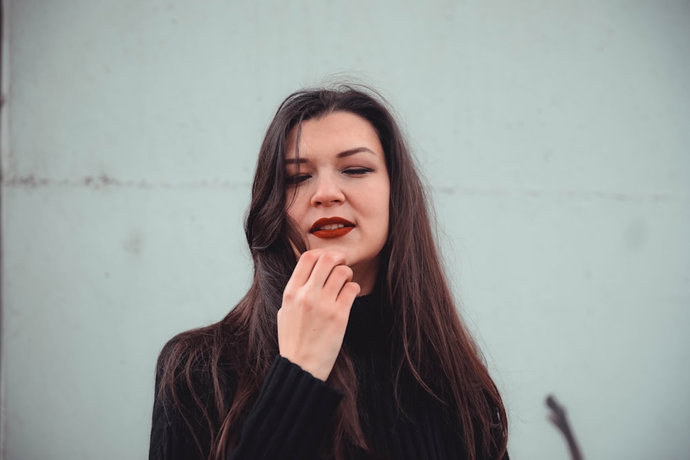 woman about to touch her chin