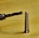 A close-up of a concrete drill bit penetrating a solid wall.
