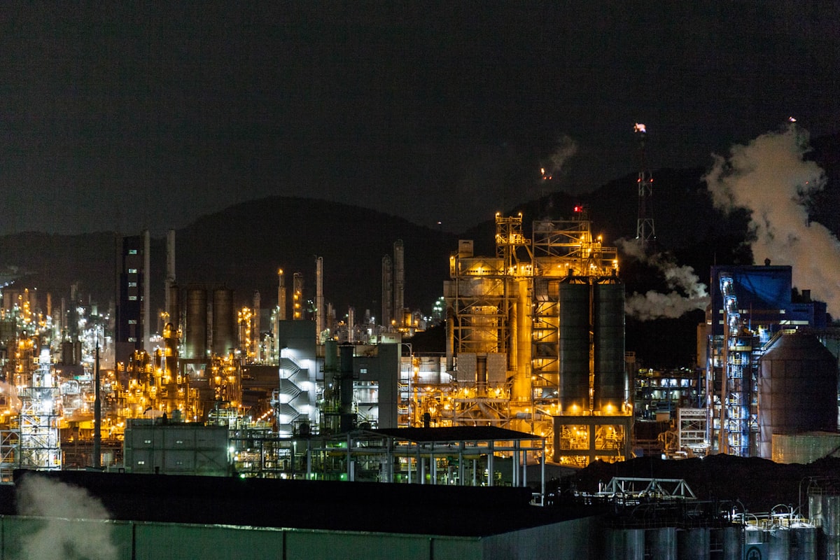 Industrial chemical factory at night representing the manufacturing sector's transformation