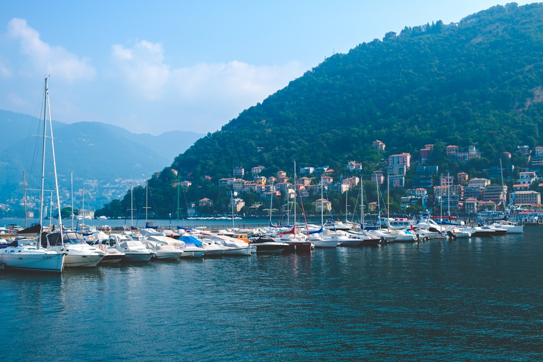 boats on body of water besides mountain