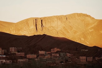 A candid shot of Arif Wazir filming a mountain village at dawn with intimate natural light.