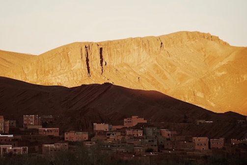 A candid shot of Arif Wazir filming a mountain village at dawn with intimate natural light.