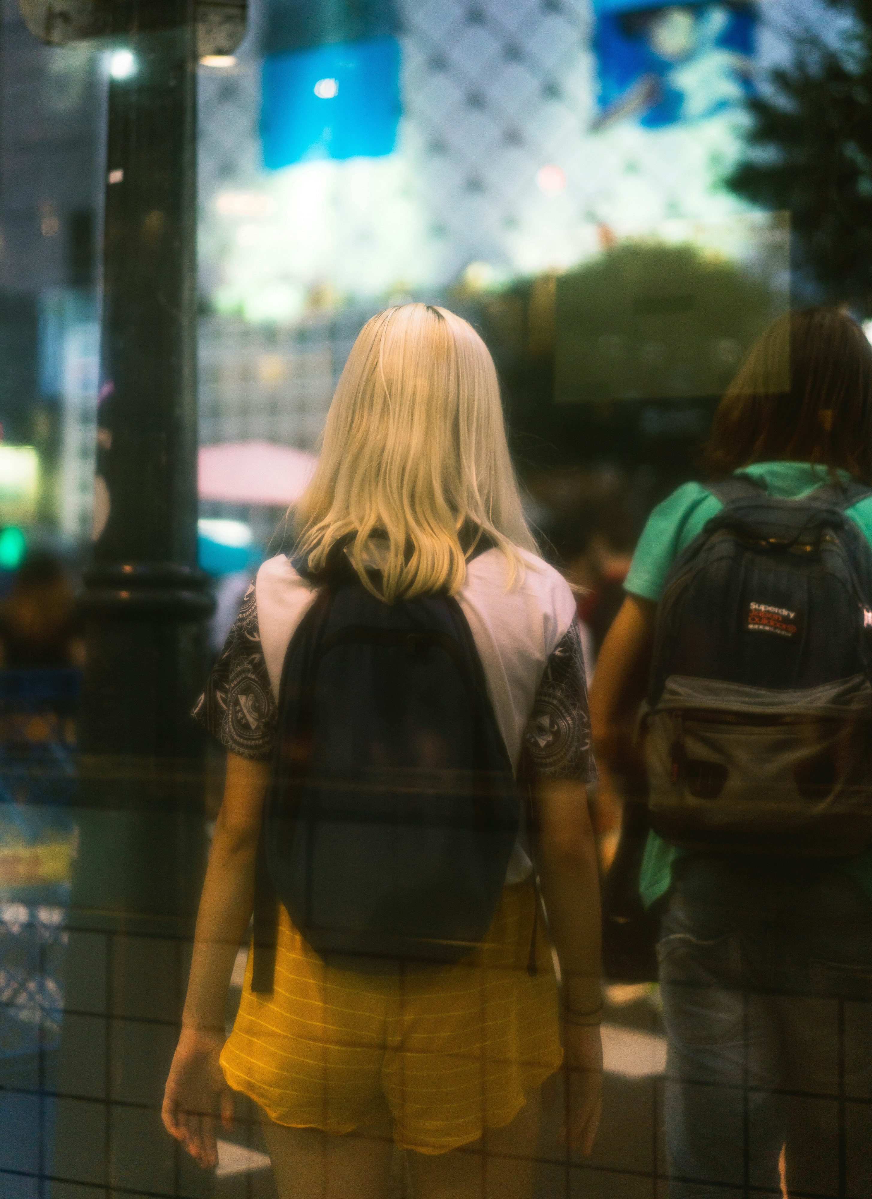 traveller with backpack walking through a city street