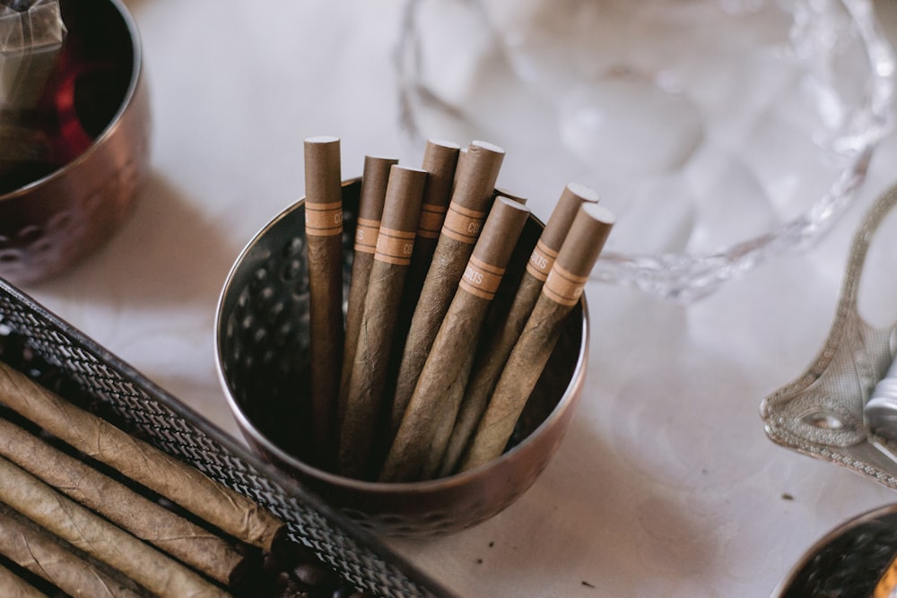 brown cigars on stainless steel bowl