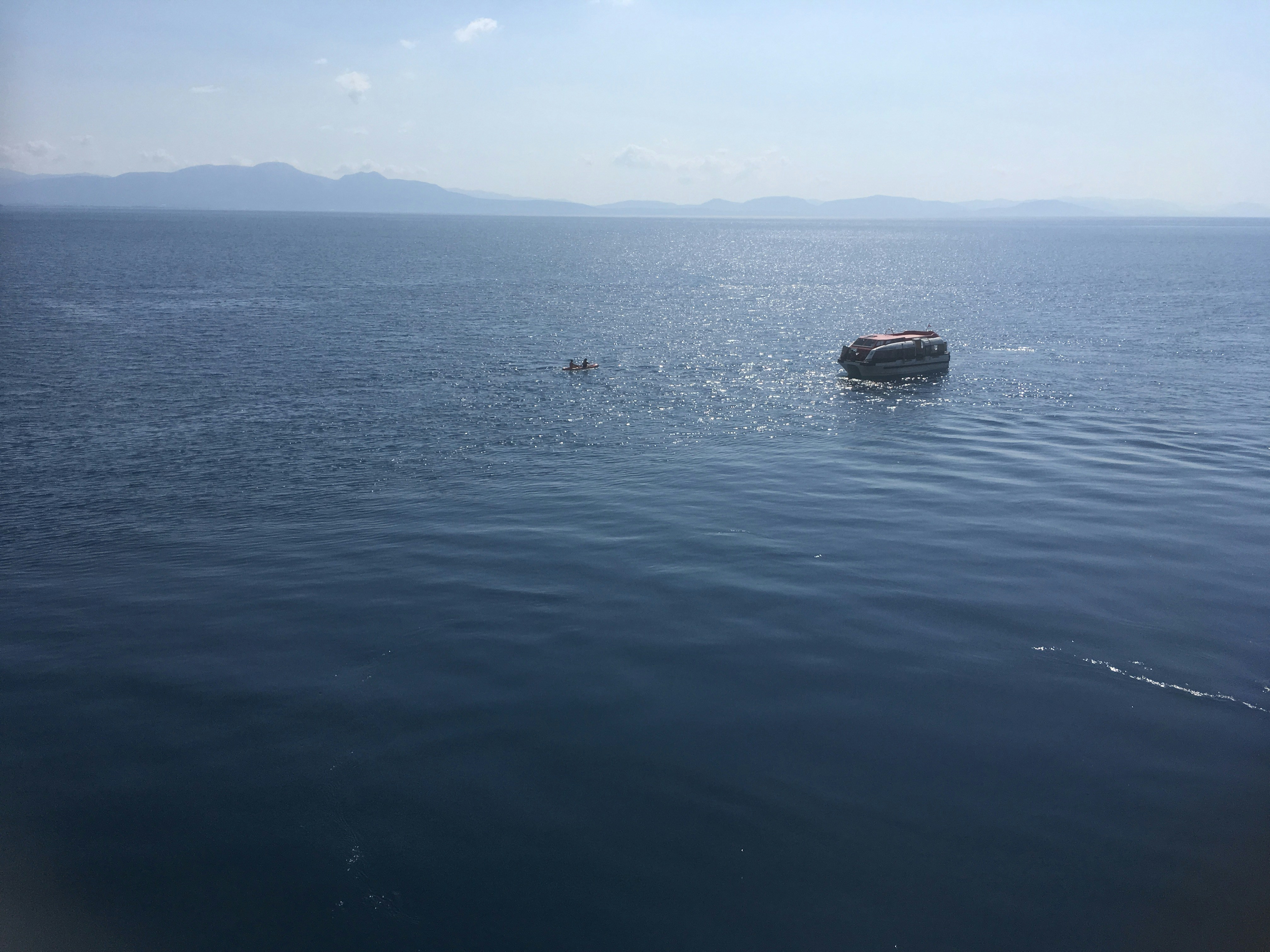 a boat floating on top of a large body of water