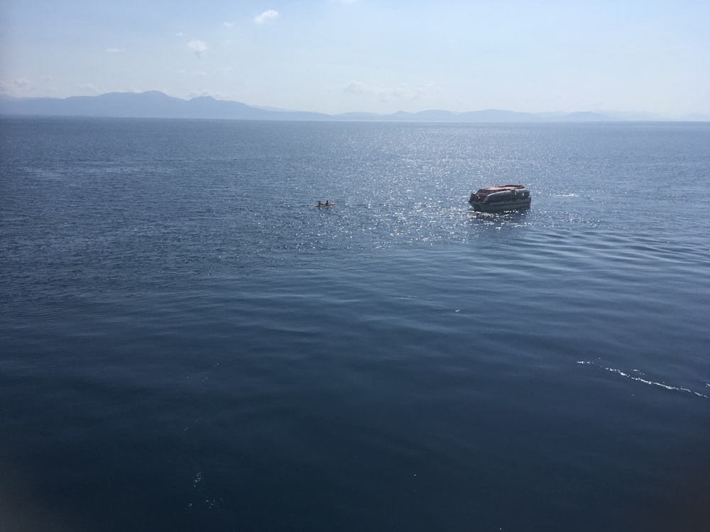 a boat floating on top of a large body of water