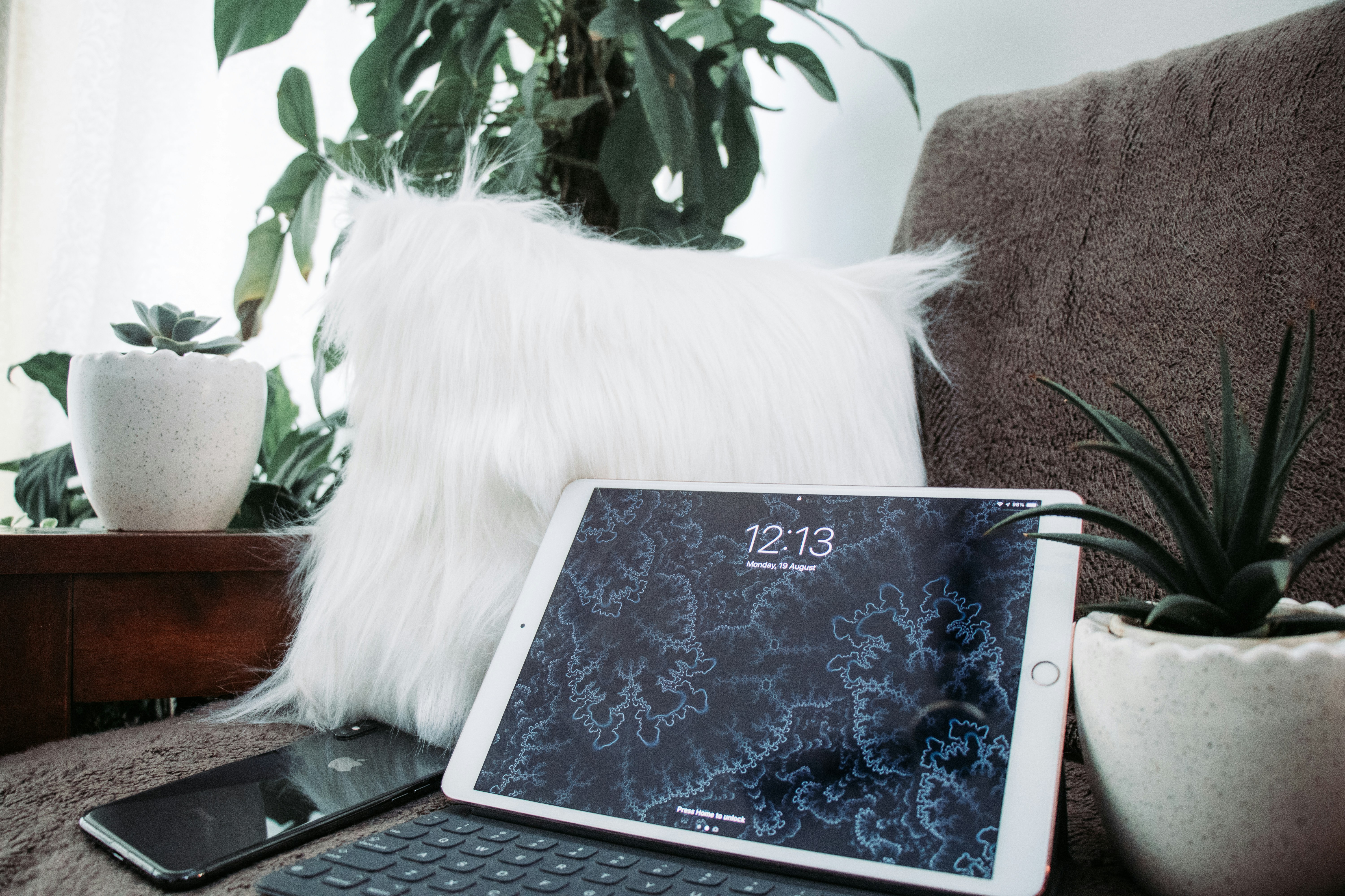 Silver iPad on black couch