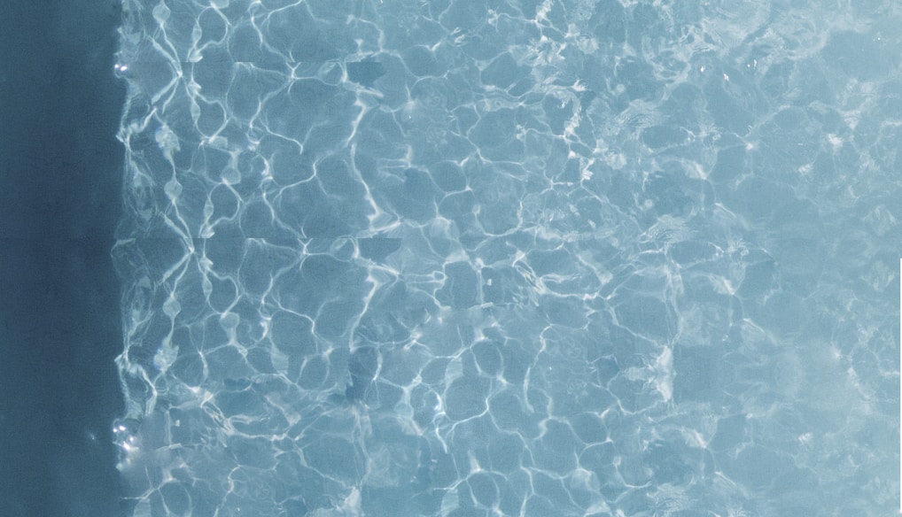 person about to dive on swimming pool