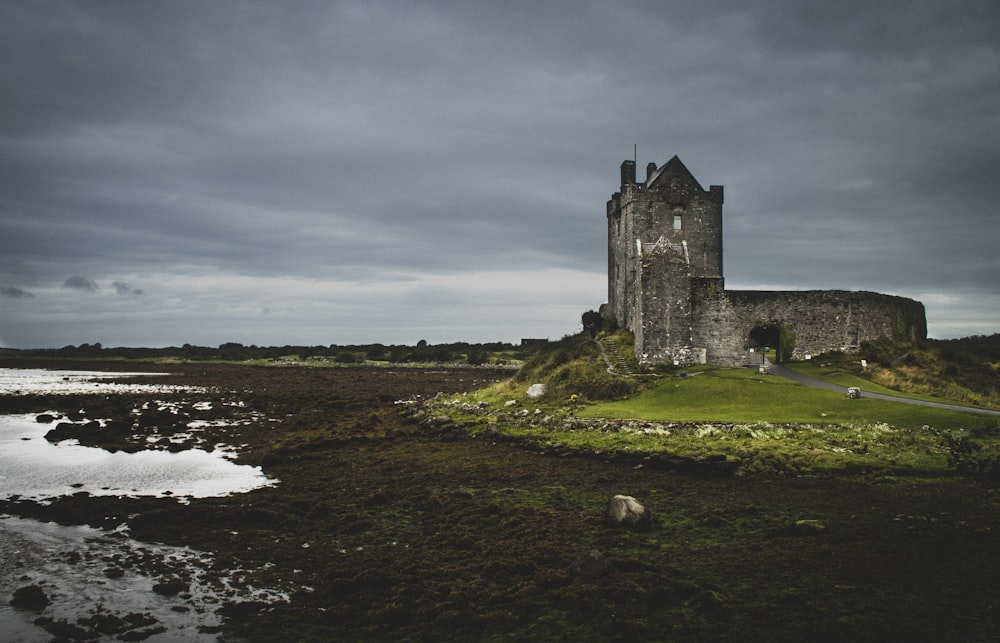 gray concrete cathedral beside body of water