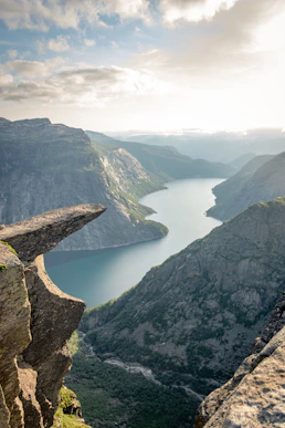 photo of mountain and ocean scenery