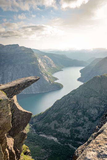 photo of mountain and ocean scenery