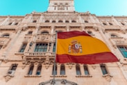 flag on pole beside building during day