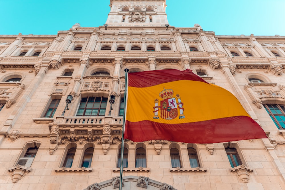 flag on pole beside building during day